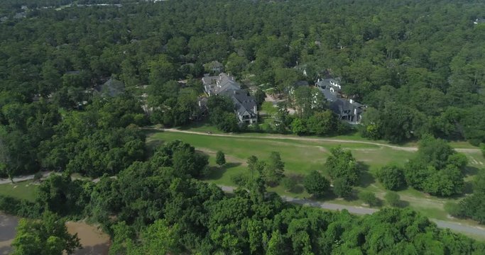 Aerial view of affluent homes next to the Buffalo Bayou in Houston, Texas. This video was filmed in 4k for best image quality.