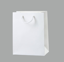 Paper white bag isolated on grey background.