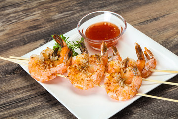 Grilled prawn skewer with sauce