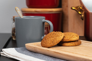 Cup of hot coffee on wooden board on kitchen table close up