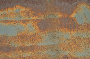 the rusted surface of painted metal garage door