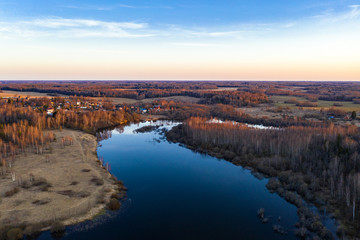 Fototapeta na wymiar River Uvod in the rays of the setting sun in the area of the village of Rozhnovo, photo from a drone.