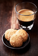 Butter cookies and Coffee in glass cup on rustic wooden background. Close up.	