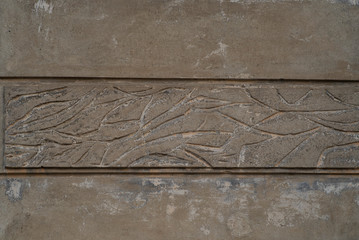 the decorative ornament on the plaster of the old house