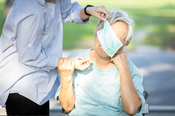 Asian senior woman in a mask,is being bullied by society during the outbreak of Coronavirus,Covid-19 pandemic,she is not a virus,problems of bullying,anti racism,stop physical abuse,violence and hate