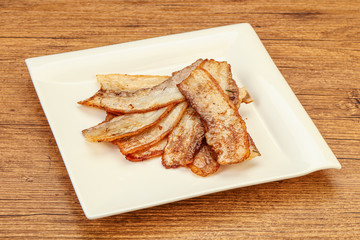 Roasted juicy bacon in the plate