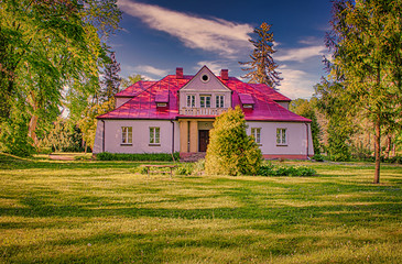 Historic manor in Sedziejowice, Poland surrounded by an old park.