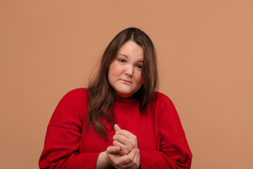 Sad beautiful girl with an upset face. Bright clothes.