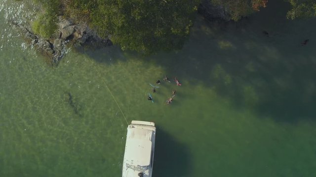 Epic aerial of friends enjoying the waters of Scotland Bay located on the Caribbean island of Trinidad