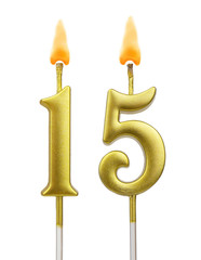 Burning golden birthday candles on white background, number 15