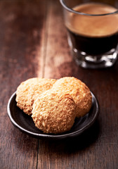 Butter cookies and Coffee in glass cup on rustic wooden background. Close up.