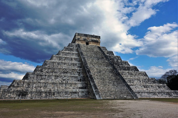 Wonder of the world. The mysterious pyramid of Cuculcan in Mexico. Ancient stone step pyramid with an altar on top. The mystery of the Mayan civilization. A staircase leads upstairs. Picturesque cloud