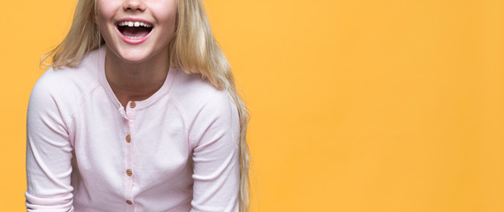 Close-up smiling girl on yellow background
