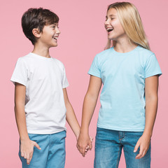 Young siblings holding hands. Girl and boy.