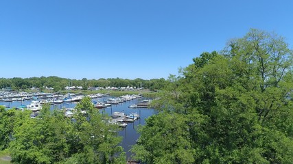 Bird's eye view of boats in a marina at tree tops