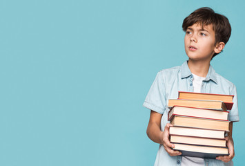 Copy-space young boy holding books