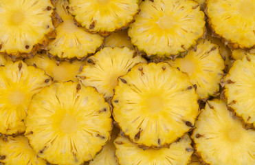 Many pineapple slices as background
