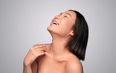 Cheerful Asian woman with clean skin