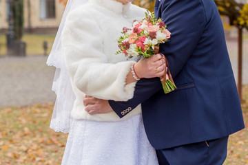 groom with a bride and a bouquet of flowers
