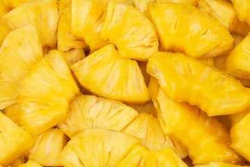 Many juicy pineapple slices as background
