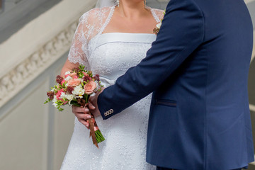 groom with a bride and a bouquet of flowers