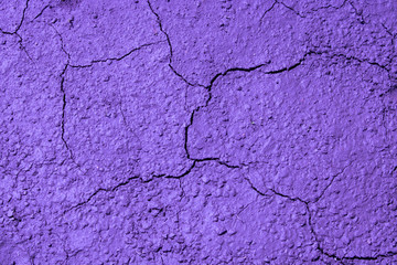 Cracked lilac surface with a variety of textures.Abstract background