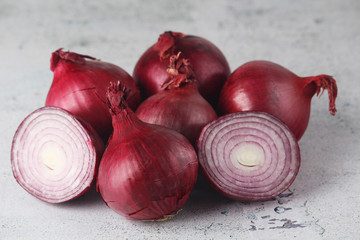 Three red onions on the table