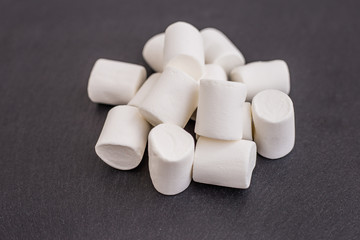 Fototapeta na wymiar white marshmallow sweets on dark background