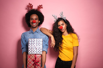 African couple with presents and horns on their heads.