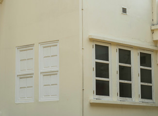 closed windows on pale yellow wall