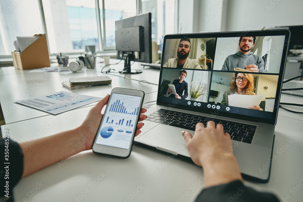 Aufkleber Meeting via video conferencing app: manager using sales analysis graph while discussing strategy with colleagues via video chat on laptop