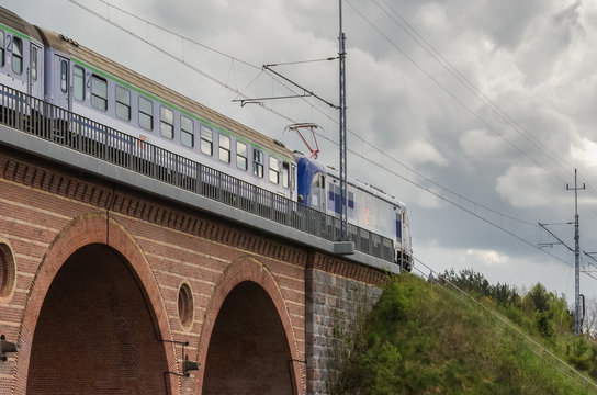KARLINO, WEST POEMARANIAN / POLAND - 2020: The express train travels through the viaduct along the railway route
