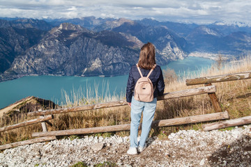 Naklejka premium Tourist on viewpoint of Monte Baldo on Lake Garda in autumn