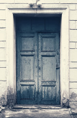 Wooden vintage door. Ancient entrance concept background. Grunge aged and textured doorway backdrop.