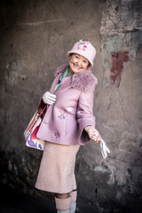 Beautiful women in older age with fantastic taste on style with herself made hat.