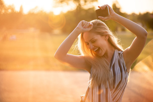 Carefree young woman dancing in joy