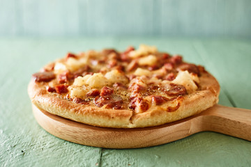 Pizza with bacon and sausage.