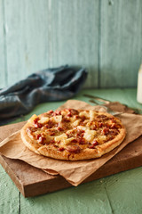 Pizza with bacon and sausage.