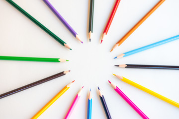 Fototapeta premium colored pencils in circle on white background