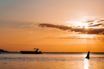 Naklejka na ściany i meble Boat at sunset in the Indian ocean off the coast of Mauritius.