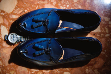 The groom is gathering in the morning. Men's classic patent leather shoes. Wedding details. Eau de toilette, perfume, watch.