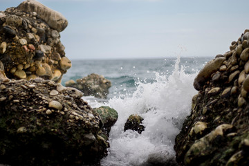 Waves crashing at stones in Andalucia Spain