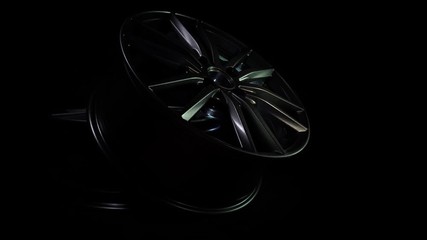 Modern automotive alloy wheel made of aluminum on a black background, industry. Designer fashion wheels for car, mechanic, copy space
