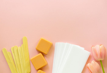 Set for wax hair removal on a pink background