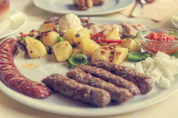 Delicious barbeque food served on plate for two.