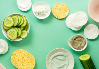 Flat lay of face care products on a mint background