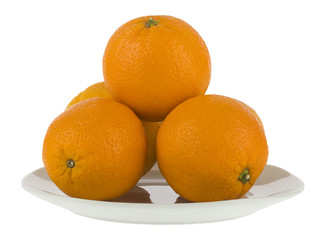 Oranges in a white plate isolated on a white background close-up.