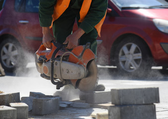 Sawing a block with a circular saw, road construction.