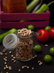 Person holding a pink wooden box with groats beans and lentils and olive oil. Food Delivery concept. Mediterranean diet concept. 