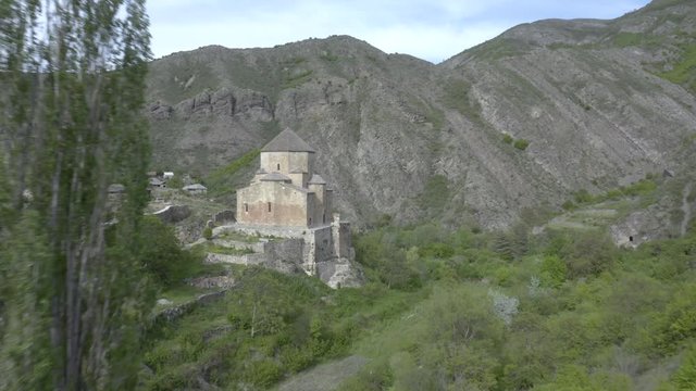 Flying Over The Beautiful Lush Mountain And Trees With The Ancient Church Of Ateni Sioni In Kaspi, Georgia On A Peaceful Day. - aerial drone shot